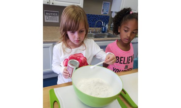 Big image girl measuring baking powder e1503432064829 1 