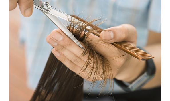 Big image hairdresser cutting woman s hair in salon focus on hair hands and scissors close up 78119917 57f6a5a55f9b586c3535c1b6