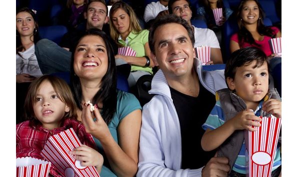 Big image hispanic family enjoying popcorn at movie theater 136589929 59b9815f6f53ba0011dfca78