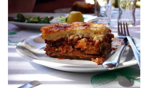 Big image moussaka with aubergine on a dish. traditional greek meal on a rustic table min 1