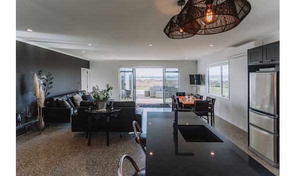 Big image pukehina retreat and lodge kitchen dining lounge